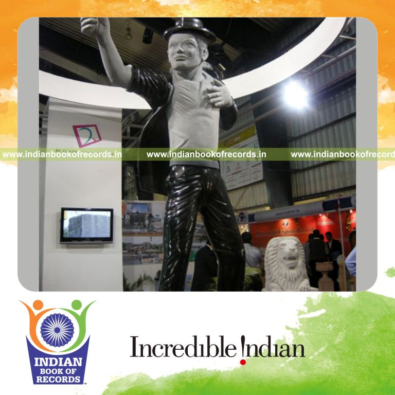 male individual creating a large granite statue for record in Indian Book of Records