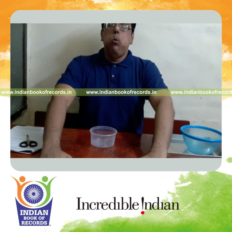 individual stuffing maximum number of blueberries into the mouth during a record attempt for Indian Book of Records