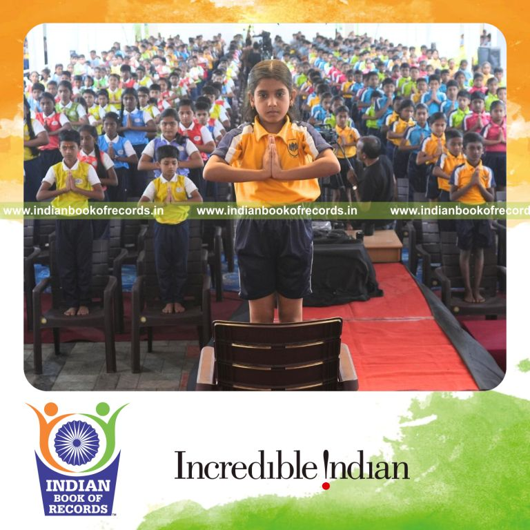 Participants performing yoga poses on chairs simultaneously in a large group setting for Indian Book of Records