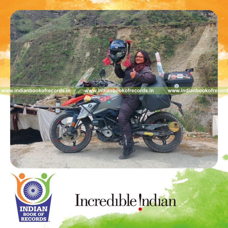 Female rider completing Char Dham spiritual motorcycle journey across India recognized by Indian Book of Records