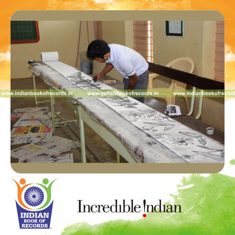 minor male creating longest charcoal drawing for Indian Book of Records
