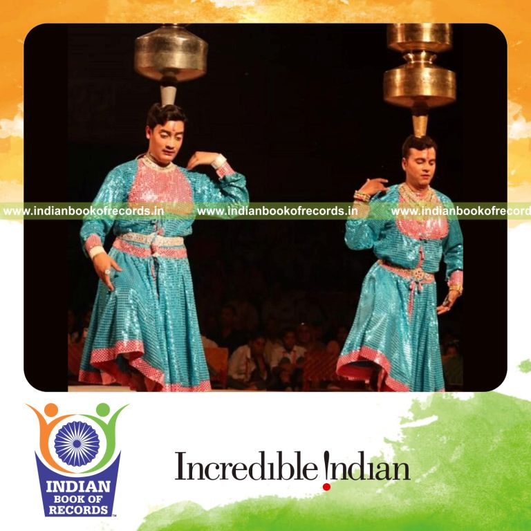 Performer executing Chari folk dance while balancing pots for an extended duration recognized by Indian Book of Records