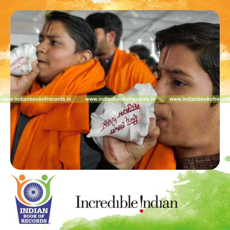 Crowd of participants blowing shankh conch shells together in a synchronized event recognized by Indian Book of Records