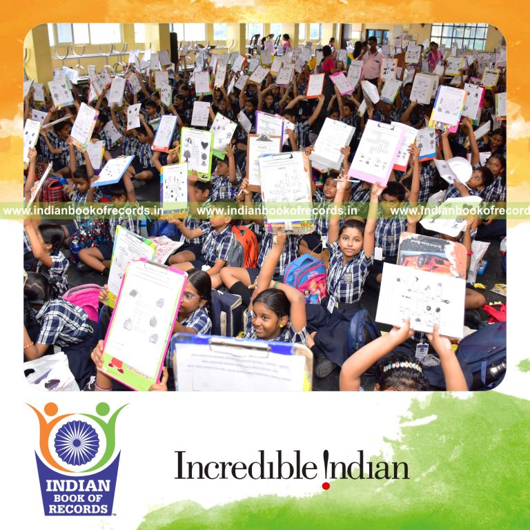 Crowd engaged in solving crossword puzzles simultaneously at a single venue for the Indian Book of Records
