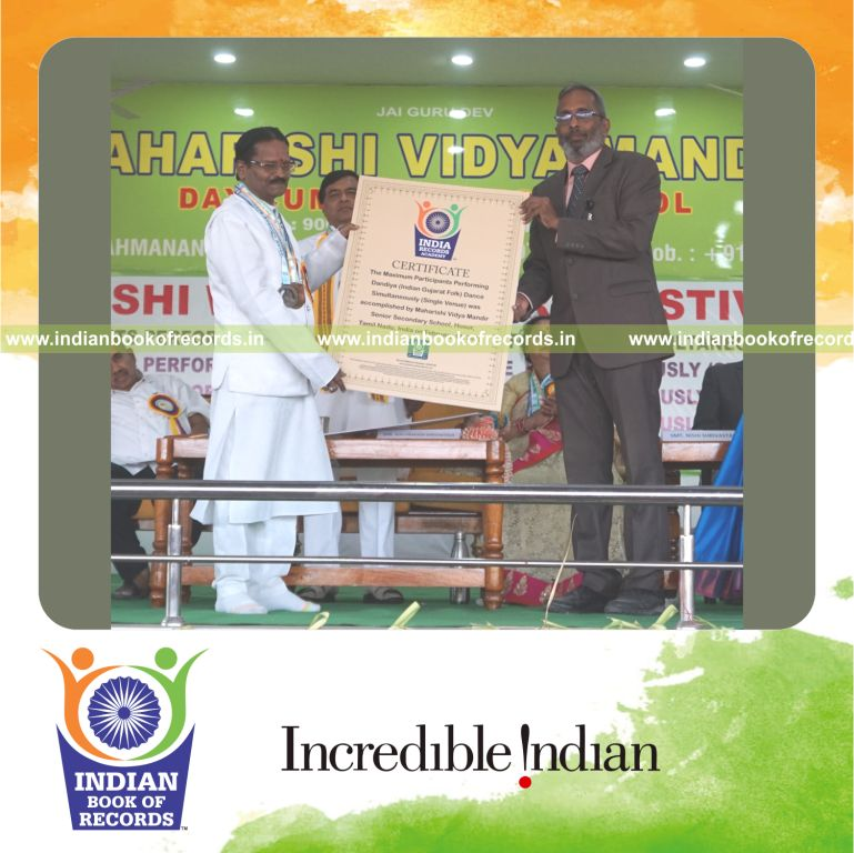 Large crowd performing traditional Dandiya dance together at a single venue for Indian Book of Records