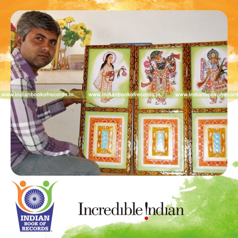 Individual combining dandvat yoga and painting during a long spiritual yatra recognized by Indian Book of Records