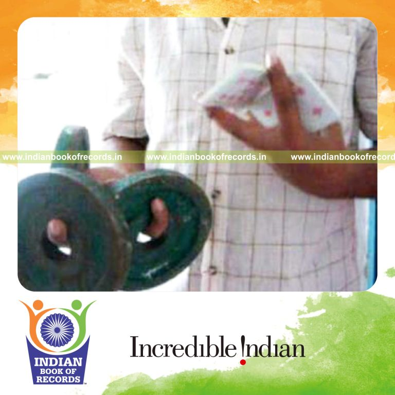 individual performing revolution card cuts while holding weight plates for record in Indian Book of Records