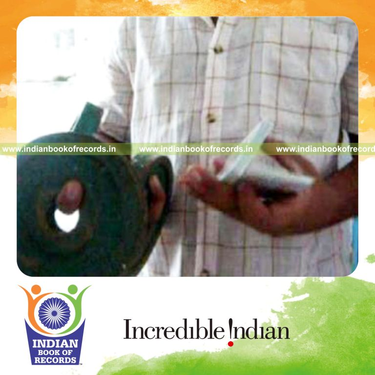 individual performing sabers flipper card cuts while holding weight plates for record in Indian Book of Records