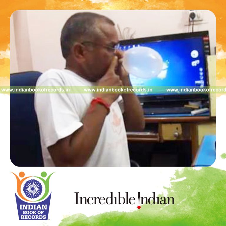 individual blowing balloon with nose until it pops for record in Indian Book of Records