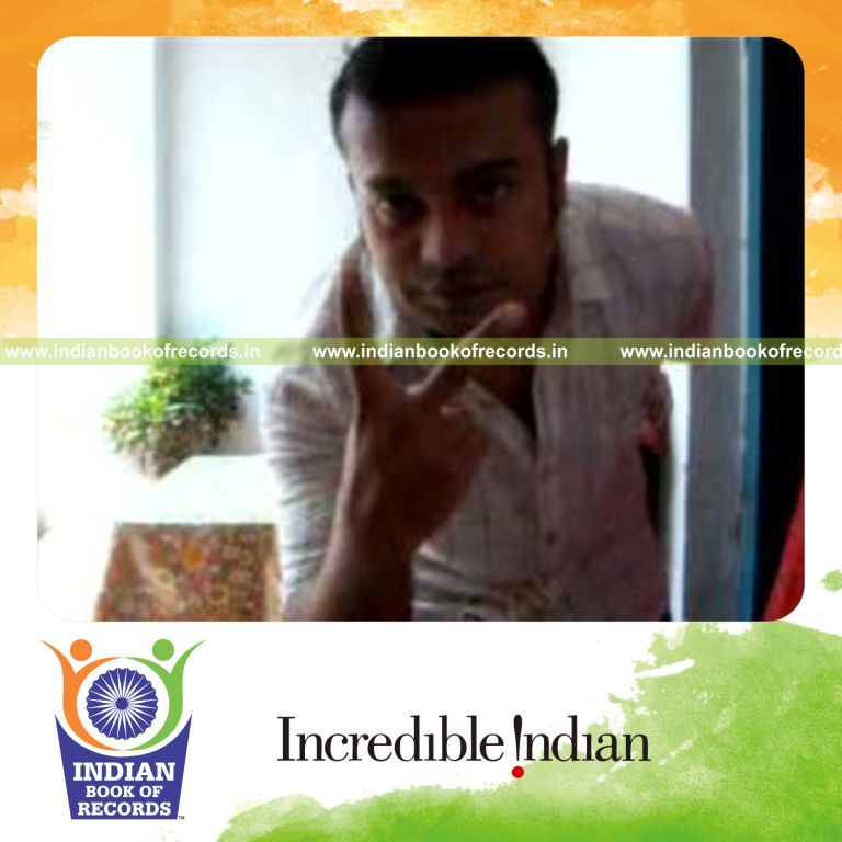 individual performing cox uker card cut behind the back for record in Indian Book of Records