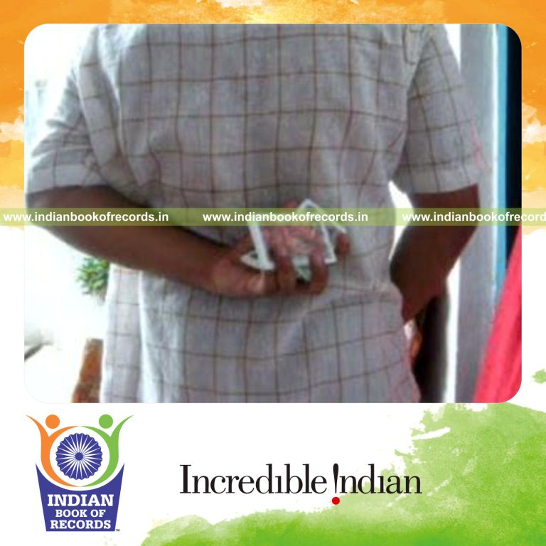 individual performing krypto cmc card cut behind the back for record in Indian Book of Records