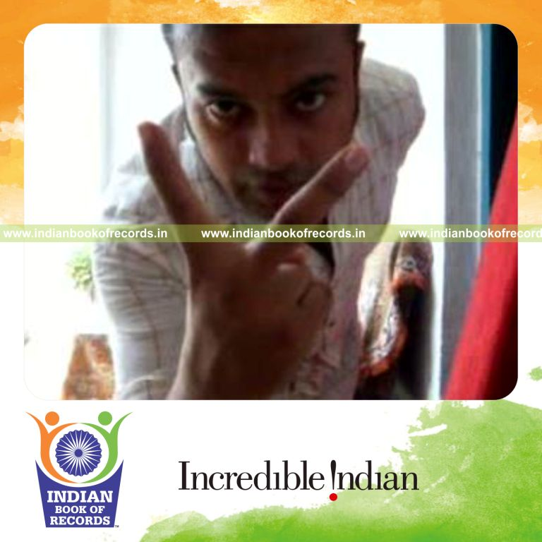 individual performing reverse scissor card cut behind the back for record in Indian Book of Records