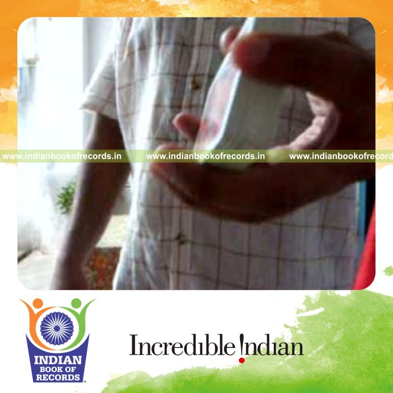 individual performing sabers revo flipped card cut behind the back for record in Indian Book of Records