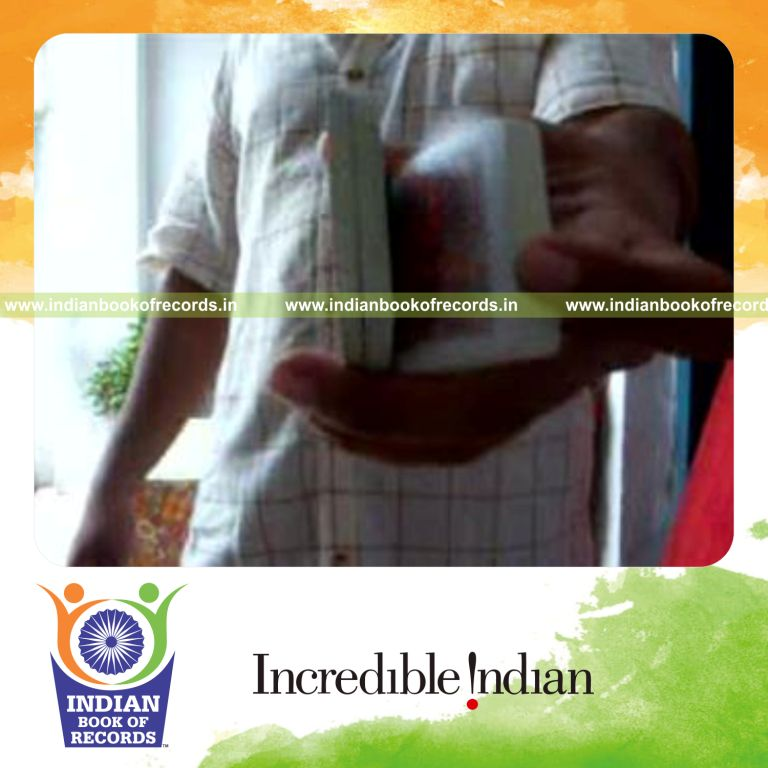 individual performing triangle card cut behind the back for record in Indian Book of Records