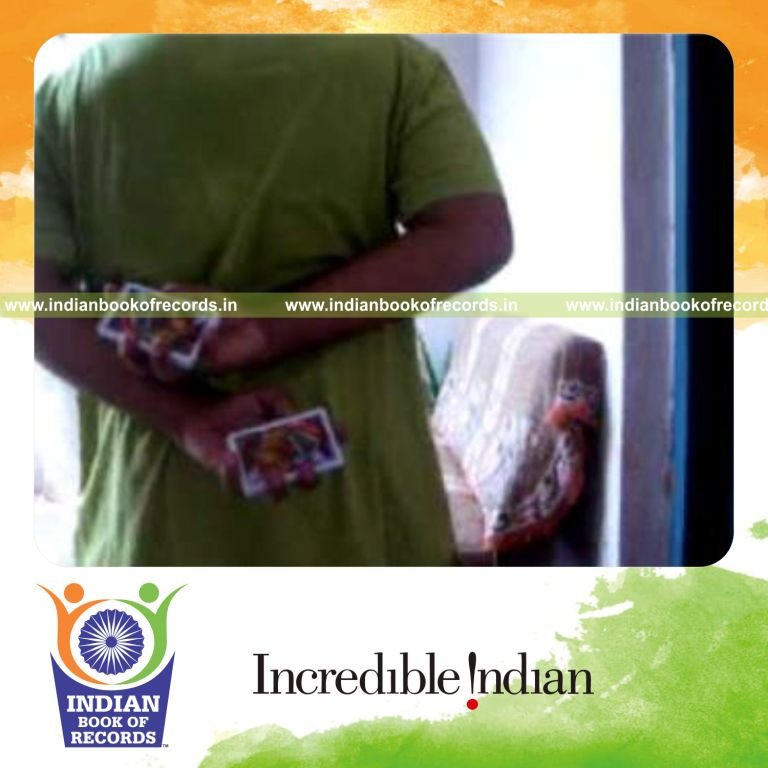 individual performing two handed chen ka card cut behind the back for record in Indian Book of Records
