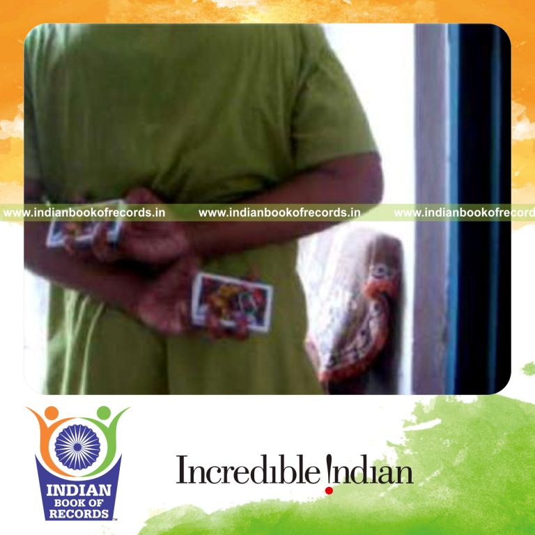 individual performing two handed knuckle card cut behind the back for record in Indian Book of Records