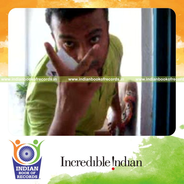 individual performing two handed kryptonite card cut behind the back for record in Indian Book of Records
