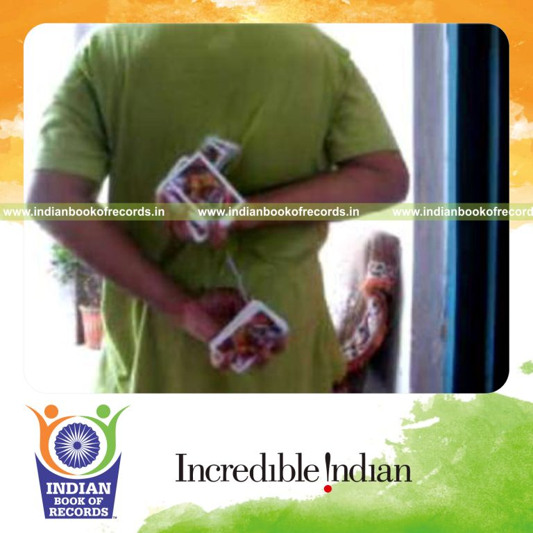 individual performing two handed muse card cut behind the back for record in Indian Book of Records
