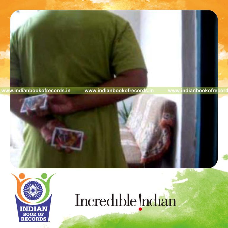 individual performing two handed reverse scissor card cut behind the back for record in Indian Book of Records