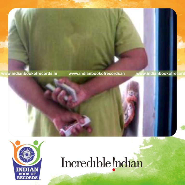 individual performing two handed revolution 2 card cut behind the back for record in Indian Book of Records