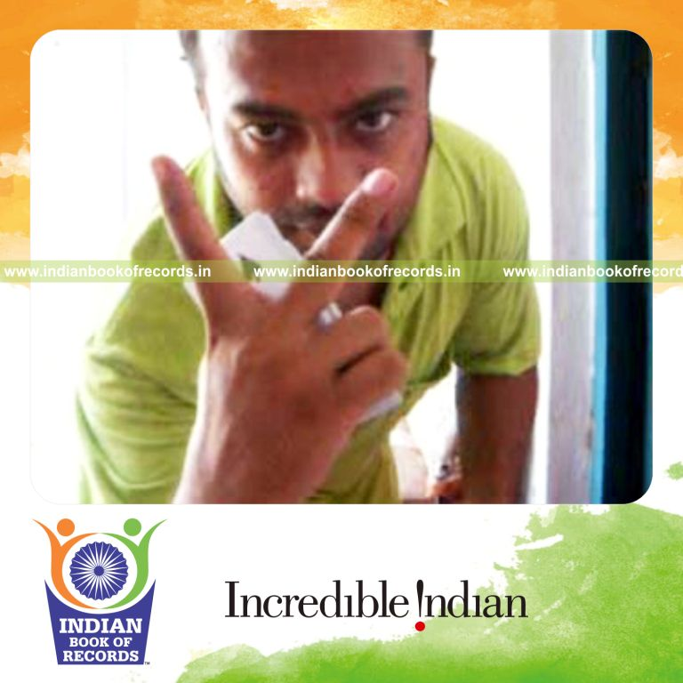 individual performing two handed thumb card cut behind the back for record in Indian Book of Records