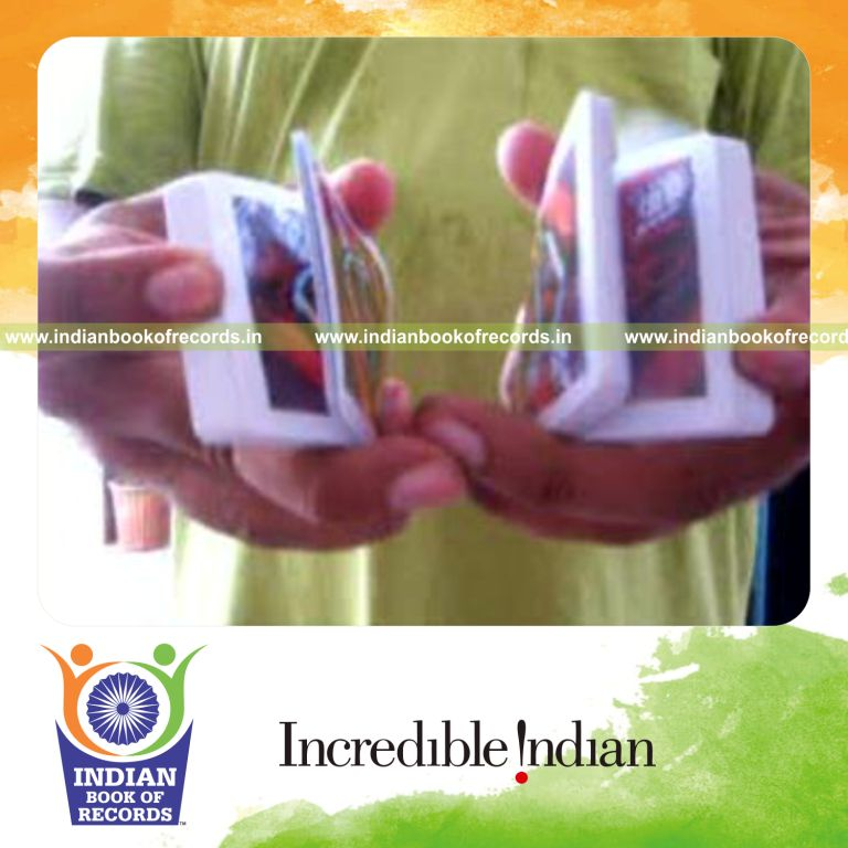 individual performing two handed triangle display card cut behind the back for record in Indian Book of Records