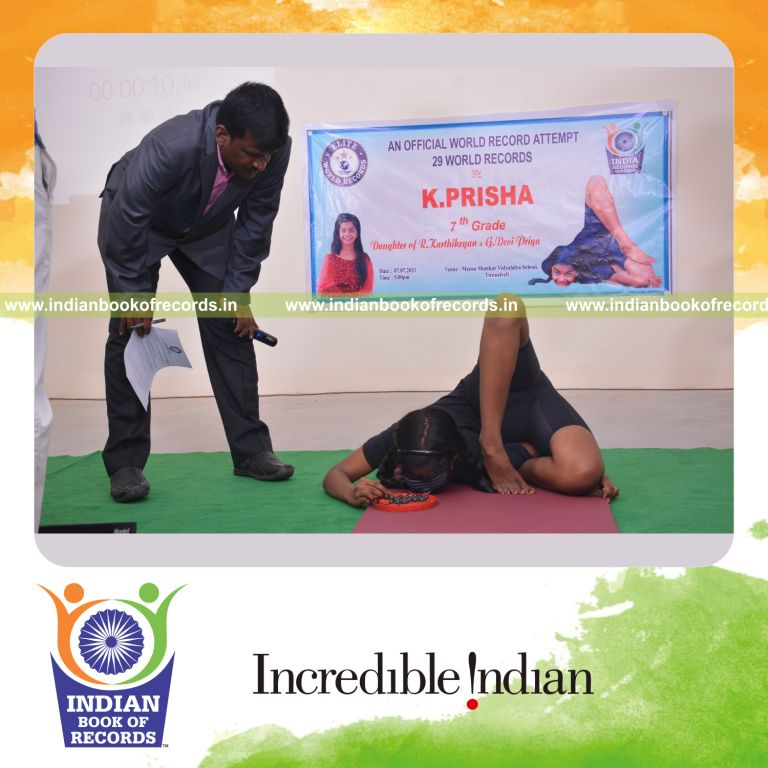 individual female solving brainvita while holding kapotasana yoga pose blindfolded for Indian Book of Records