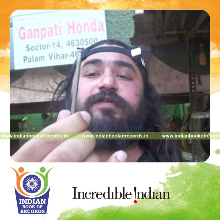 individual breaking nail in half using teeth fastest for record in Indian Book of Records
