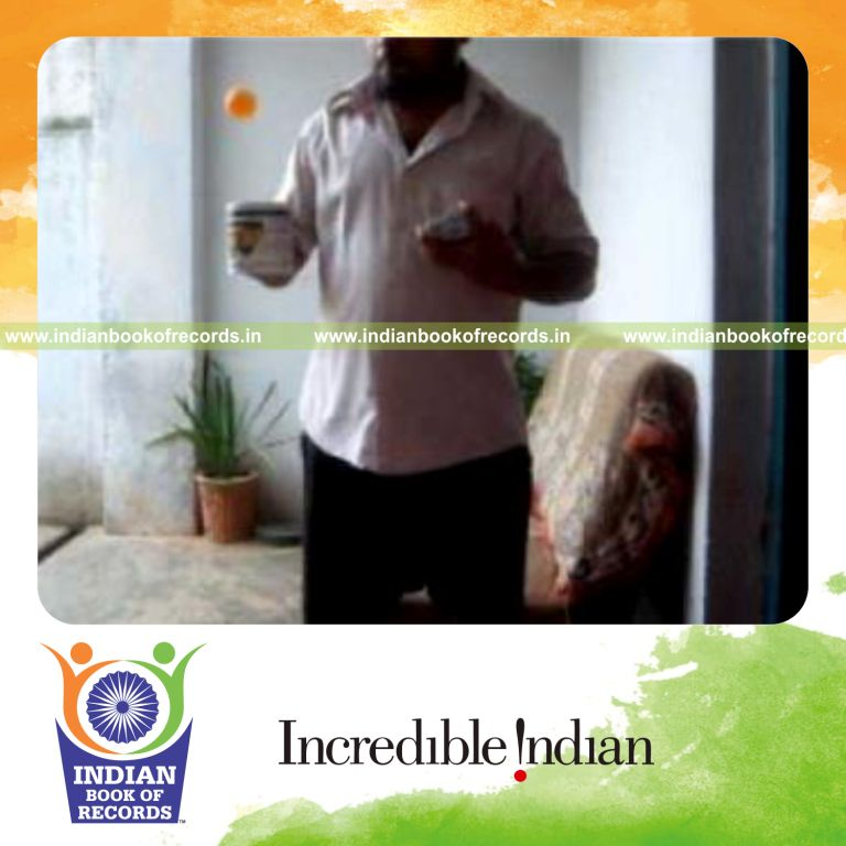 individual performing cox uker card cut while bouncing ball on coffee mug for record in Indian Book of Records