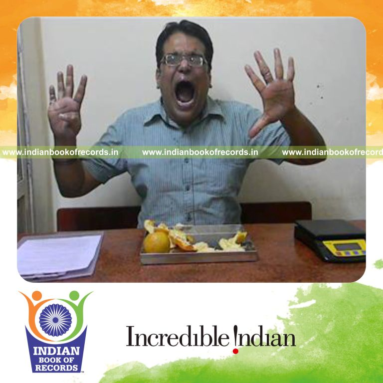 individual eating three oranges in fastest time for record in Indian Book of Records