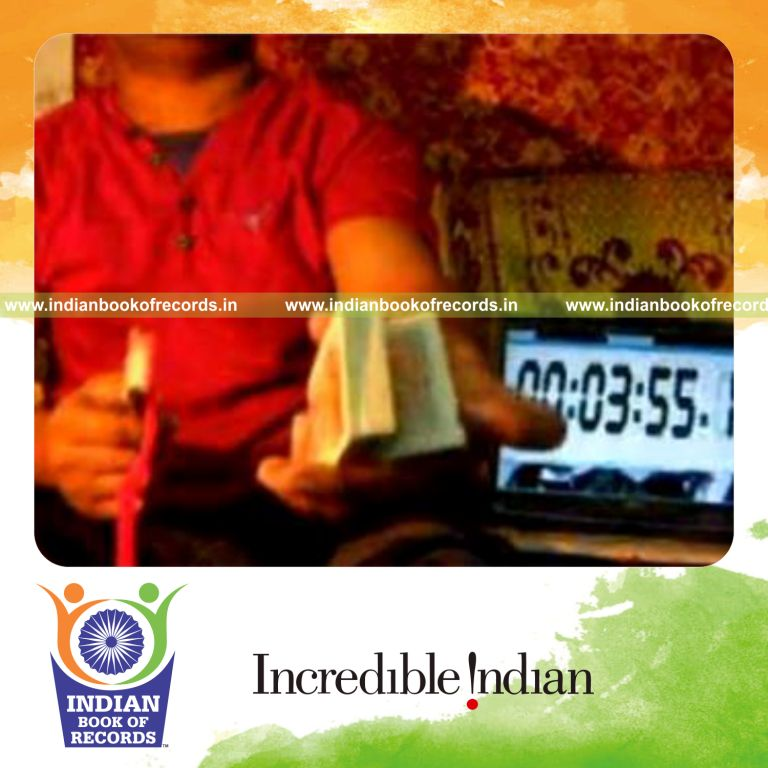 individual performing knuckle card cut while spinning toothbrush on pen for record in Indian Book of Records