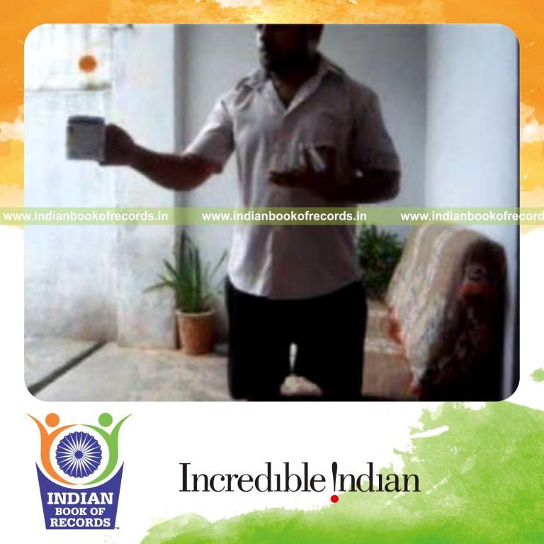 individual performing kryptonite card cut while bouncing ball on coffee mug for record in Indian Book of Records