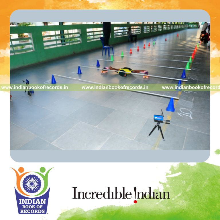 an individual performing limbo skating under multiple bars in the shortest time for a record in Indian Book of Records