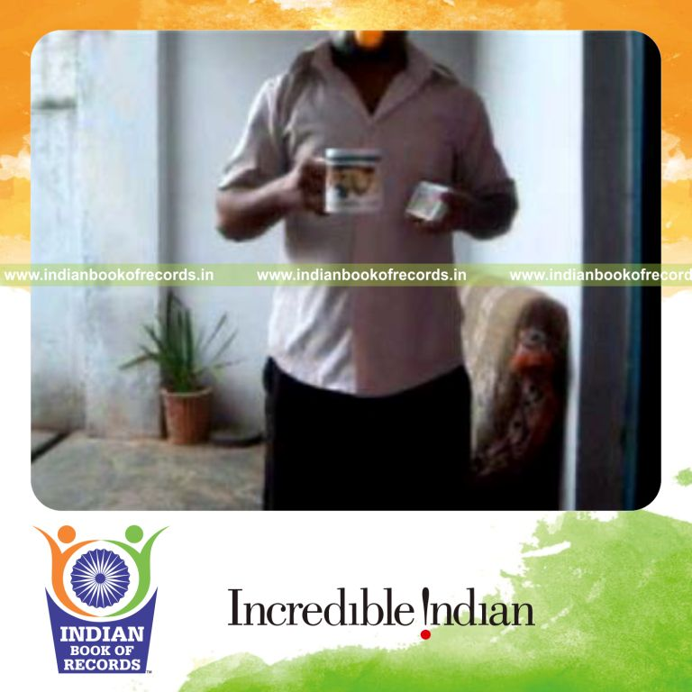 individual performing muse card cut while bouncing ball on coffee mug for record in Indian Book of Records