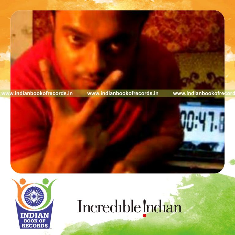 individual performing muse card cut while spinning toothbrush on pen for record in Indian Book of Records