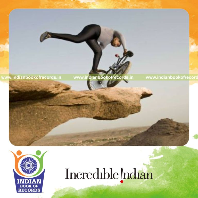 male individual performing power yoga on bmx cycle quickly for record in Indian Book of Records