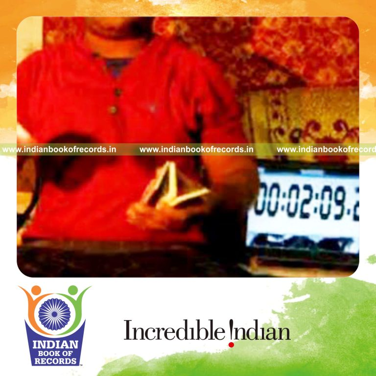 individual performing pre cmc card cut while spinning toothbrush on pen for record in Indian Book of Records