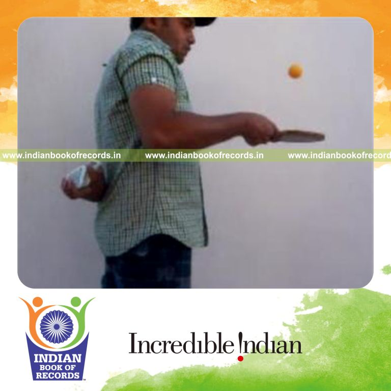 individual performing reverse revolution and cox uker cuts behind back while bouncing table tennis ball for record in Indian Book of Records