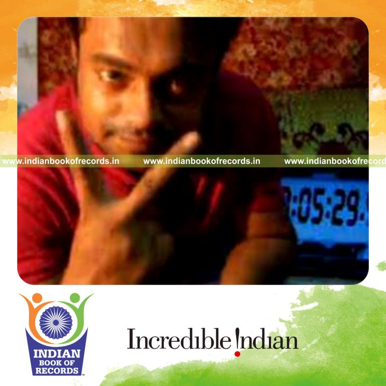 individual performing reverse scissor card cut while spinning toothbrush on pen for record in Indian Book of Records