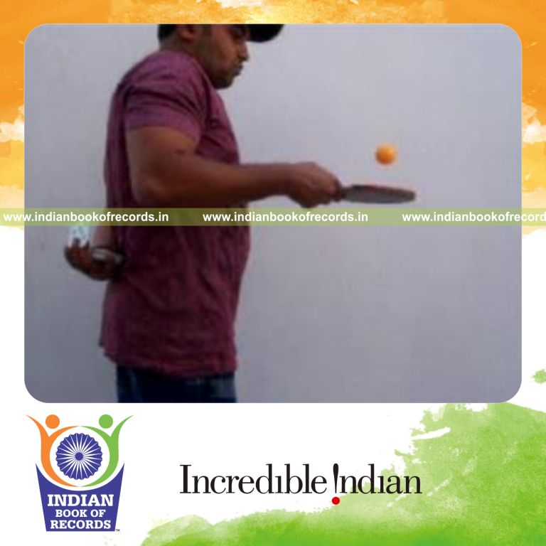 individual performing revolution and brian twist cuts behind back while bouncing table tennis ball for record in Indian Book of Records