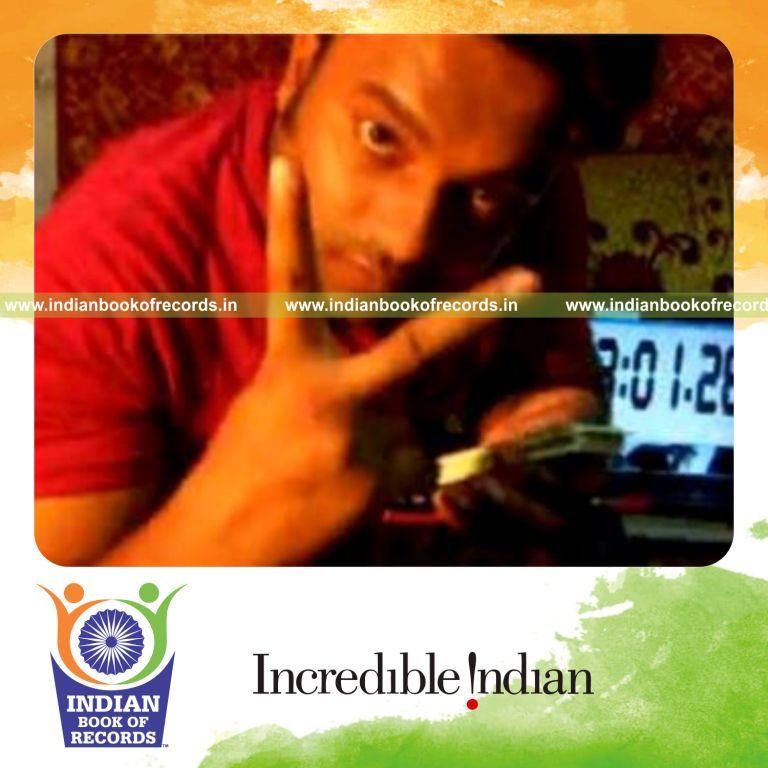 individual performing revolution card cut while spinning toothbrush on pen for record in Indian Book of Records