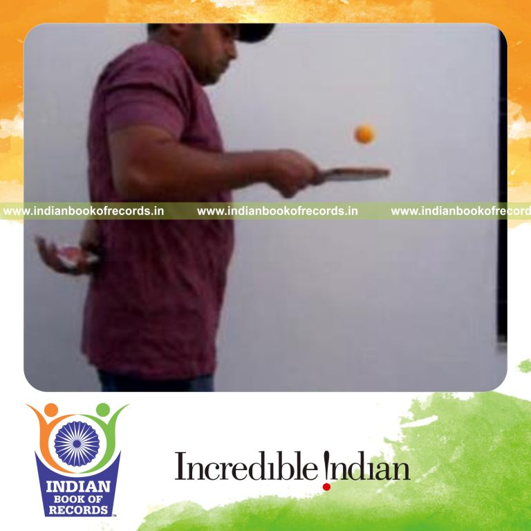 individual performing revolution and cox uker cuts behind back while bouncing table tennis ball for record in Indian Book of Records