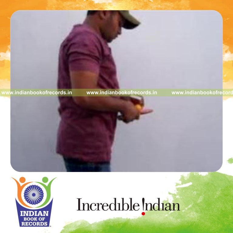 individual performing revolution and sabers flipper cuts behind back while bouncing table tennis ball for record in Indian Book of Records