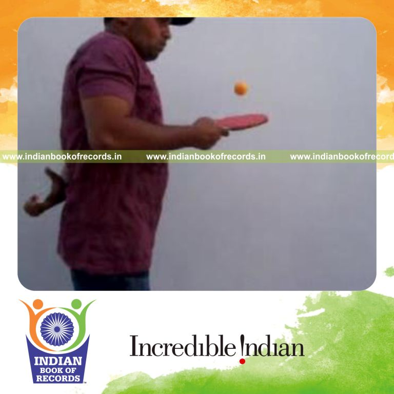 individual performing revolution and muse cuts behind back while bouncing table tennis ball for record in Indian Book of Records