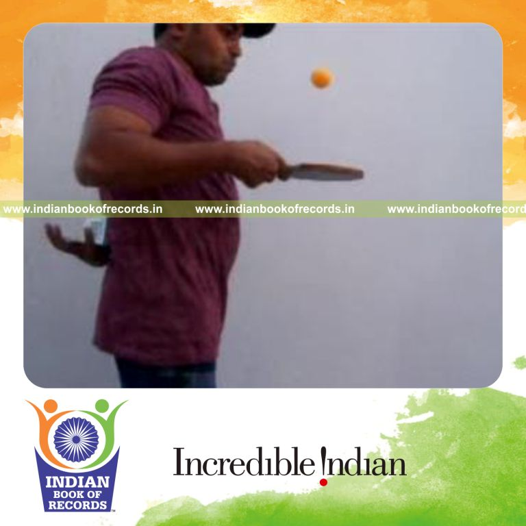 individual performing revolution and pre cmc cuts behind back while bouncing table tennis ball for record in Indian Book of Records