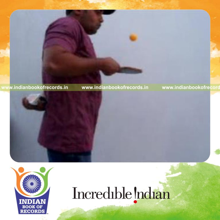 individual performing revolution and sabers revo flipped cuts behind back while bouncing table tennis ball for record in Indian Book of Records