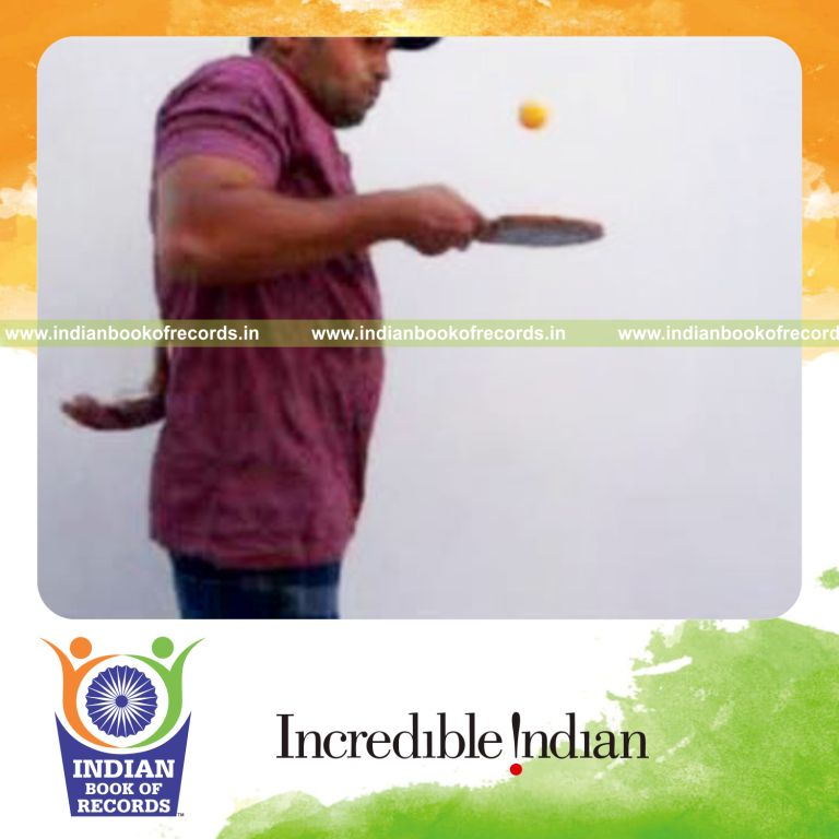 individual performing revolution and three packet thumb cuts behind back while bouncing table tennis ball for record in Indian Book of Records