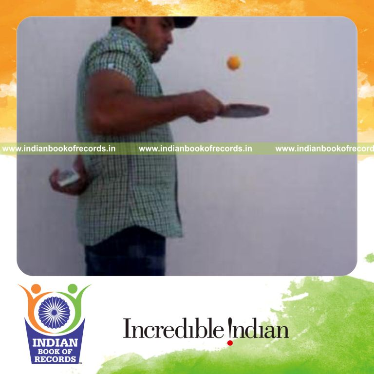 individual performing revolution 2 and cox uker cuts behind back while bouncing table tennis ball for record in Indian Book of Records