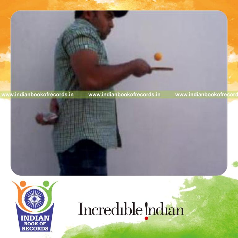 individual performing revolution 2 and sabers flipper cuts behind back while bouncing table tennis ball for record in Indian Book of Records