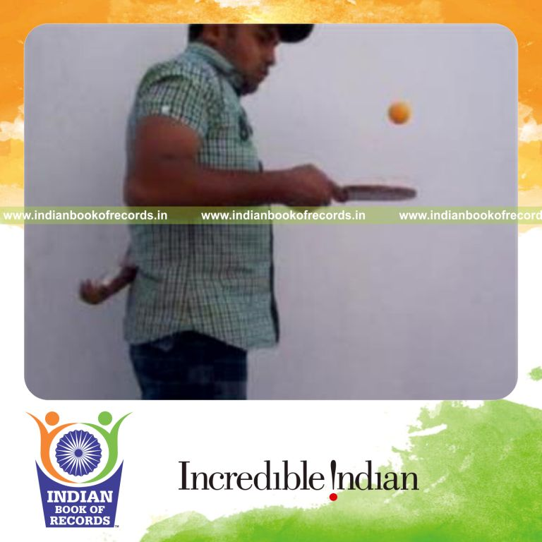 individual performing revolution 2 and muse cuts behind back while bouncing table tennis ball for record in Indian Book of Records
